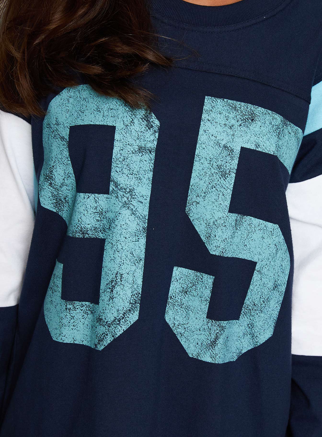 back view of model wearing Princess Polly Collegiate Queen Long Sleeved Top Navy Full Sleeves Crew Neck 