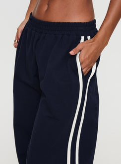 side view of model wearing Princess Polly Circuit Track Pants Navy 