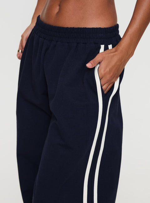 side view of model wearing Princess Polly Circuit Track Pants Navy 