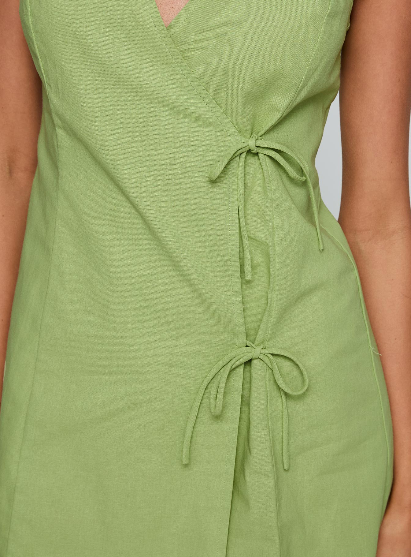 back view of model wearing Princess Polly Kodee Mini Dress Sage V-Neck 