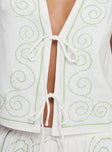 back view of model wearing Princess Polly Kindred Tie Top White / Green Sleeveless Plunger 