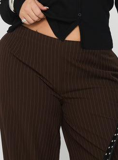 side view of model wearing Princess Polly Khane Low Rise Wide Leg Pant Brown Pinstripe Curve Low Rise Pants 