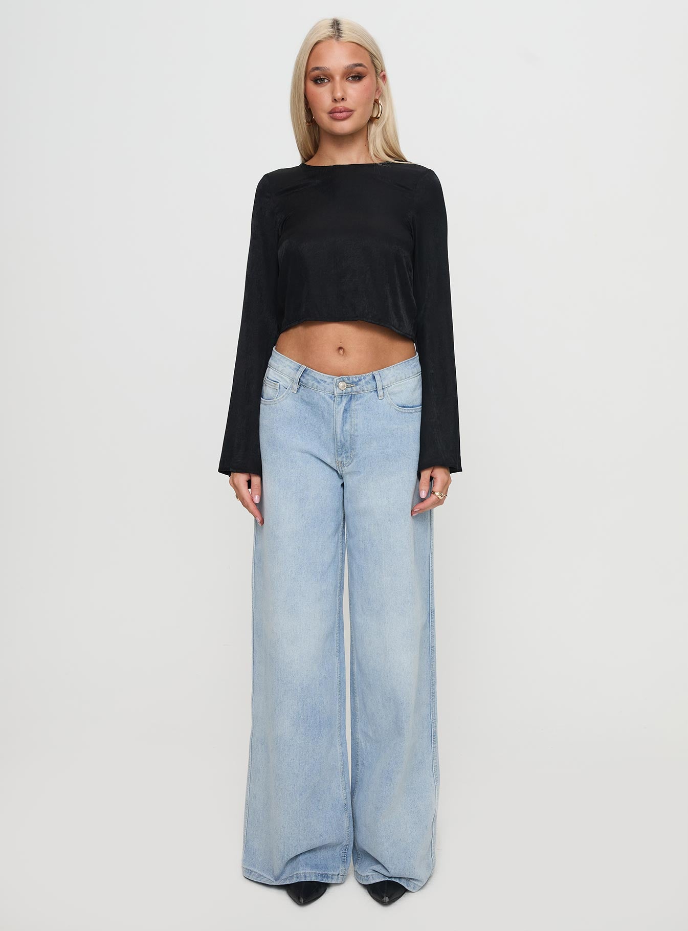 side view of model wearing Princess Polly Rhydian Long Sleeve Tie Top Black Full Sleeves Crew Neck 