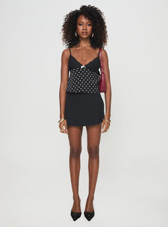 front view of model wearing Princess Polly Castien Top Black Polka Sleeveless Plunger 