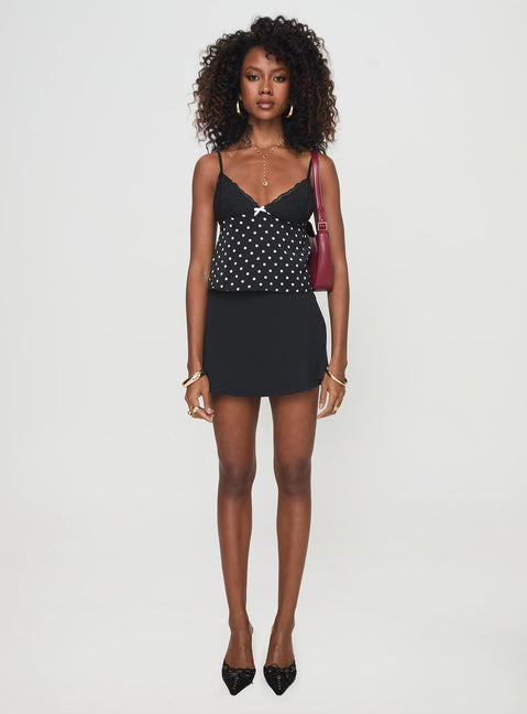 front view of model wearing Princess Polly Castien Top Black Polka Sleeveless Plunger 