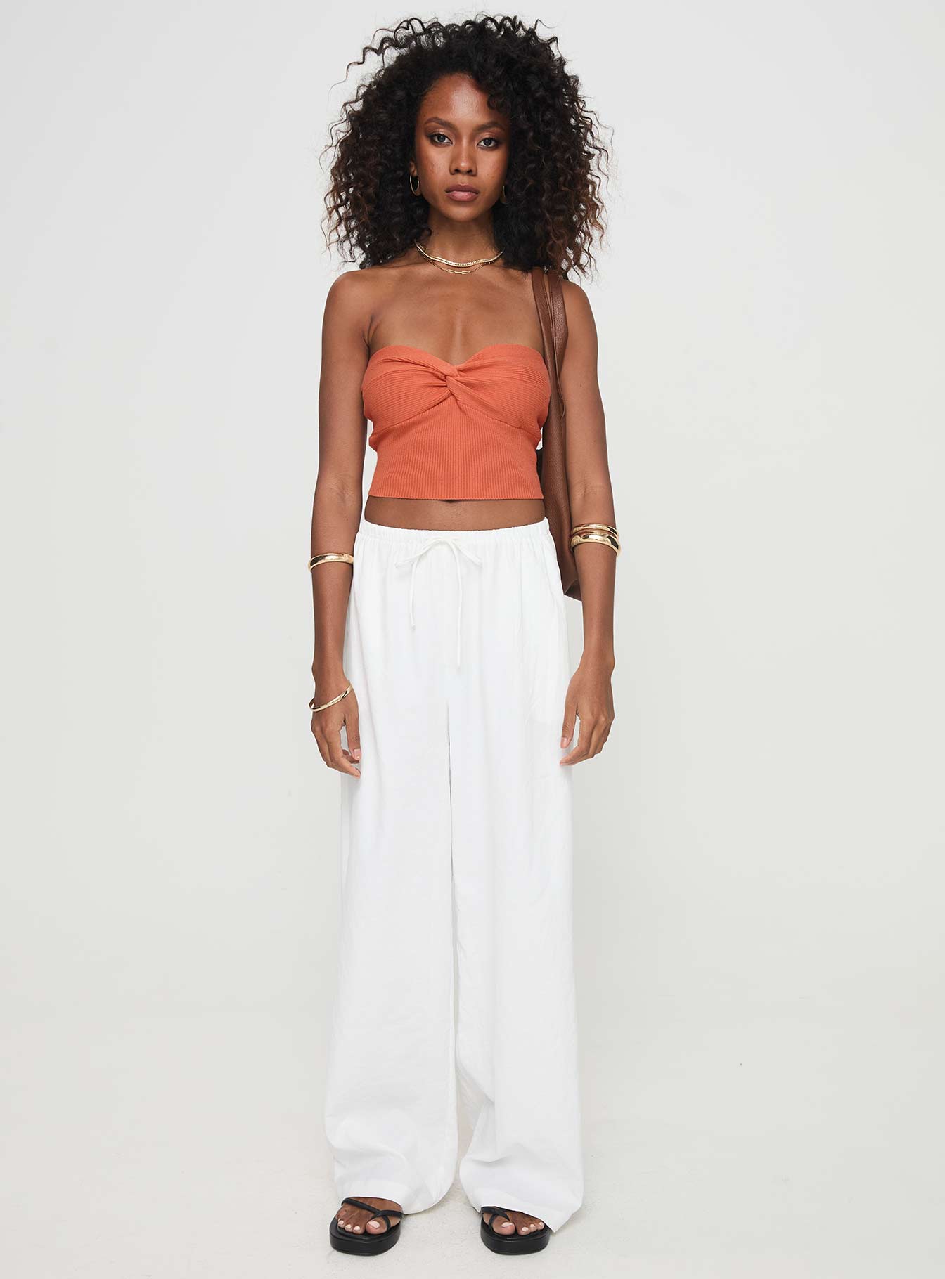 side view of model wearing Princess Polly Kallista Top Orange Sleeveless Sweetheart 