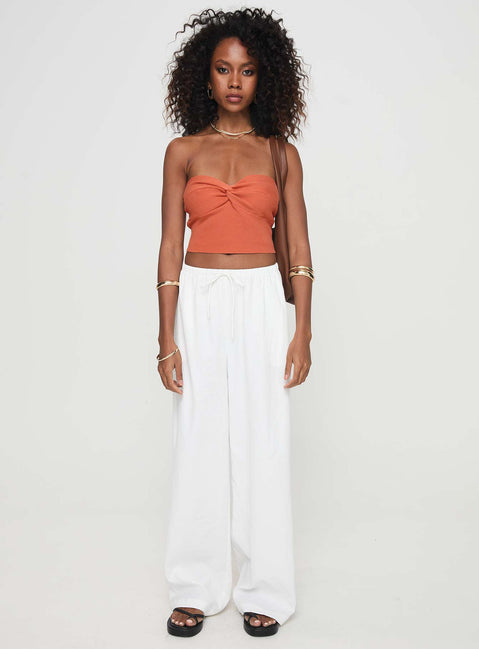 side view of model wearing Princess Polly Kallista Top Orange Sleeveless Sweetheart 