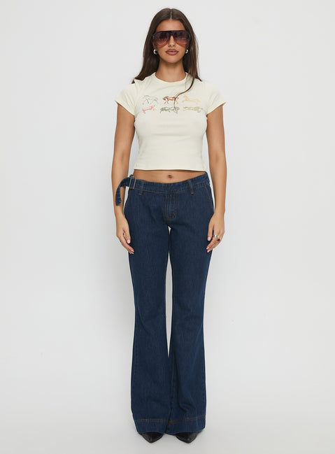 front view of model wearing Princess Polly Acapulco Low Rise Flare Jeans Dark Blue Wash Low Rise Jeans 