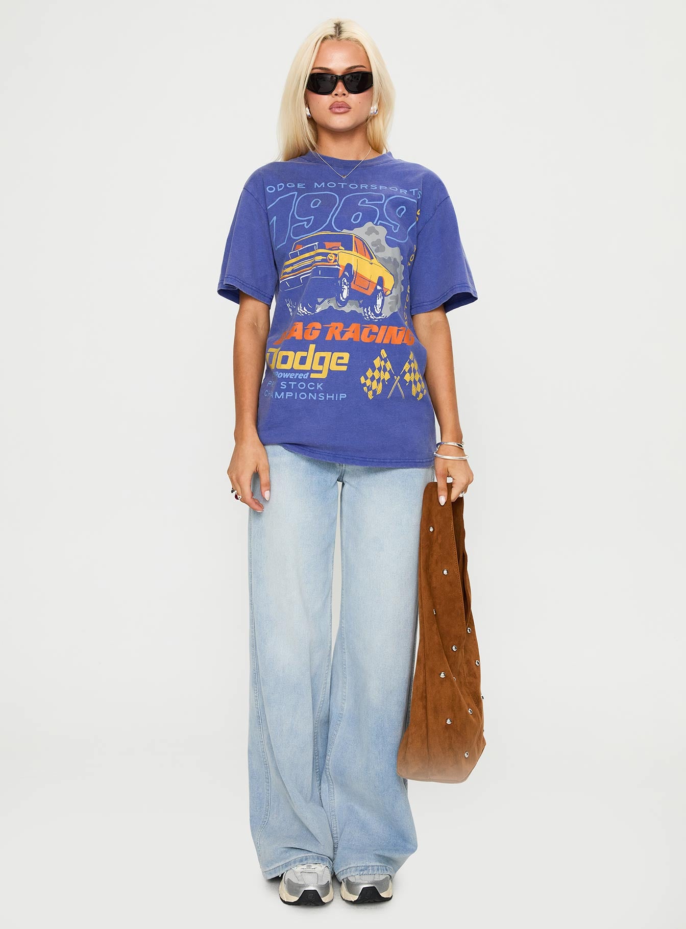 side view of model wearing Princess Polly Dodge 1969 Oversized Graphic Top Blue Half Sleeves Crew Neck 