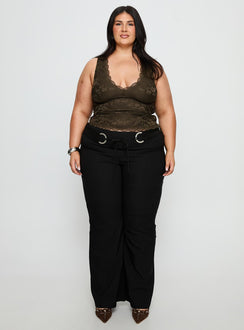 side view of model wearing Princess Polly Twinflame Low Rise Hardware Pants Black Curve Mid Rise Pants 