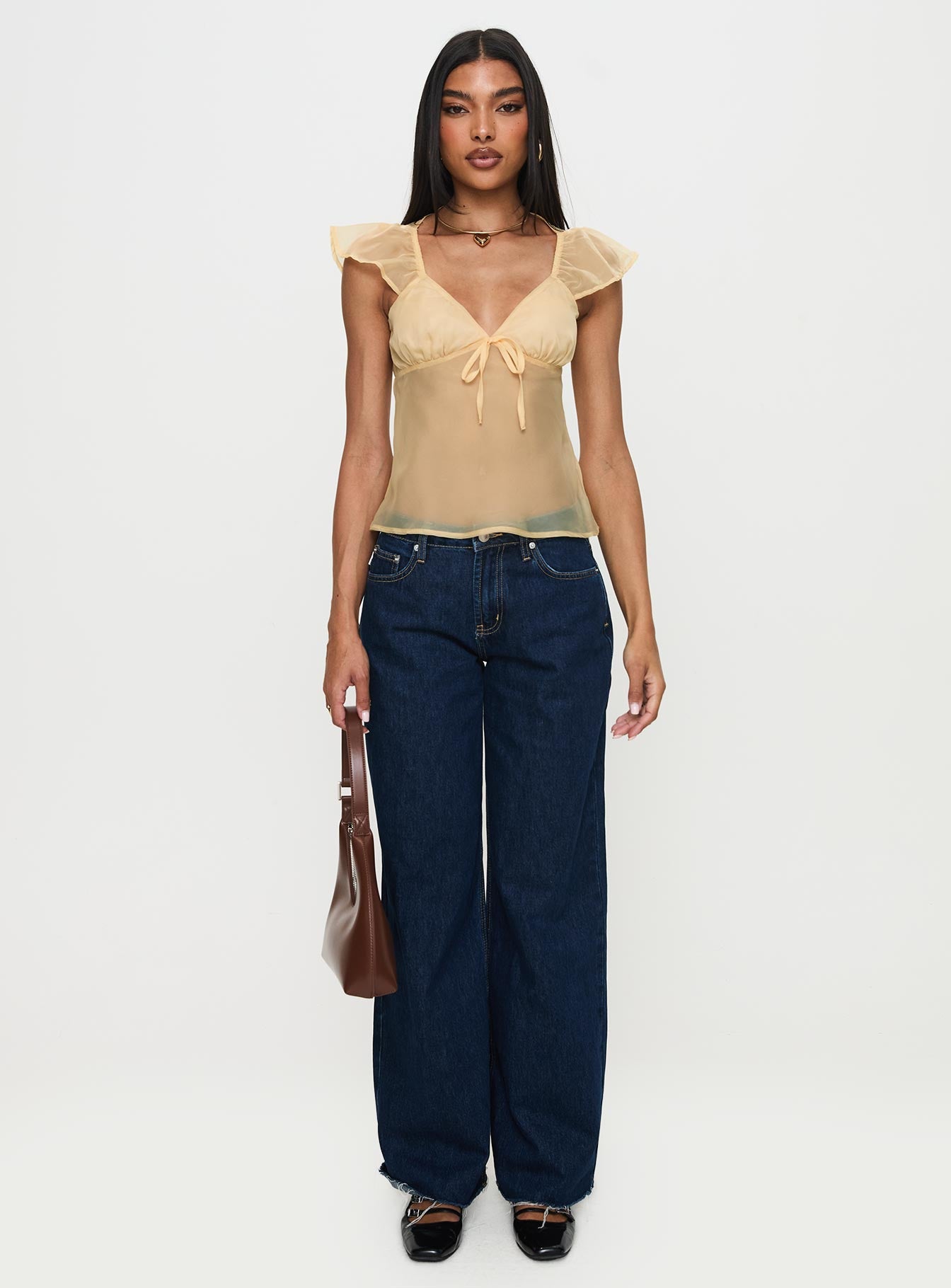 front view of model wearing Princess Polly Keysia Cap Sleeve Sheer Top Apricot Short Sleeves Plunger 