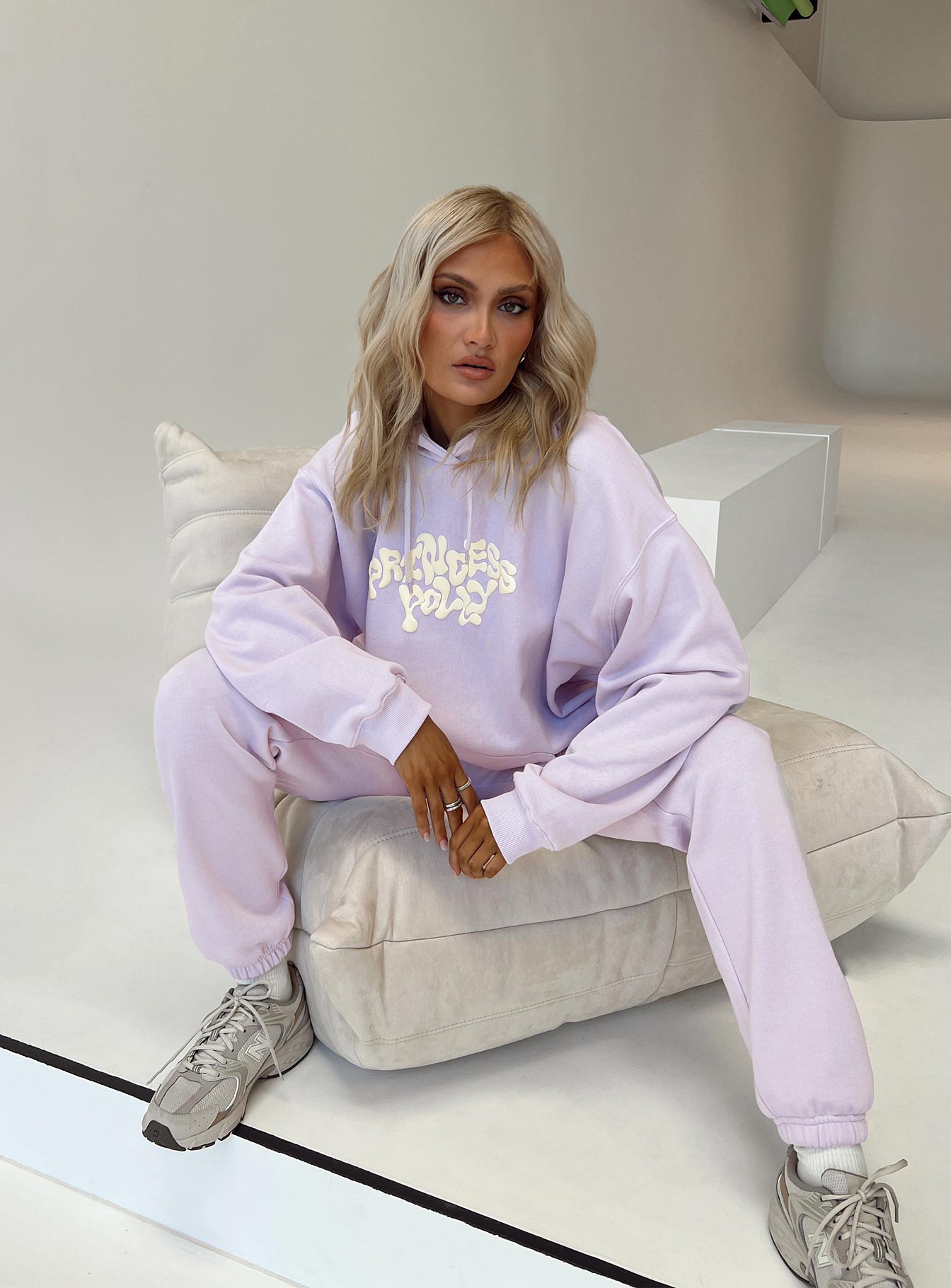 front view of model wearing Princess Polly Princess Polly Hooded Sweatshirt Squiggle Text Dusty Mauve / Eggshell regular 