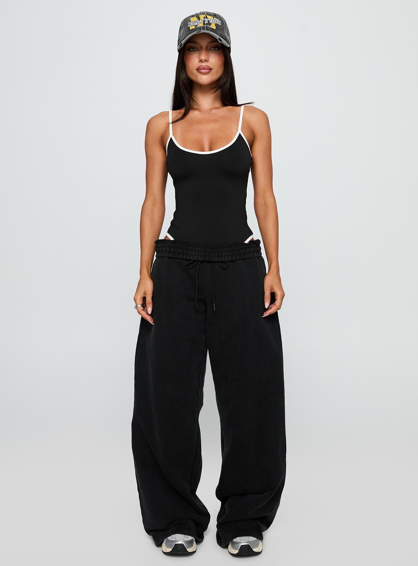 side view of model wearing Princess Polly That Effect Bodysuit Black Sleeveless 