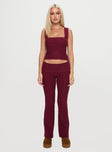 front view of model wearing Princess Polly Closed Eyes Flared Pants Maroon Low Rise Pants 