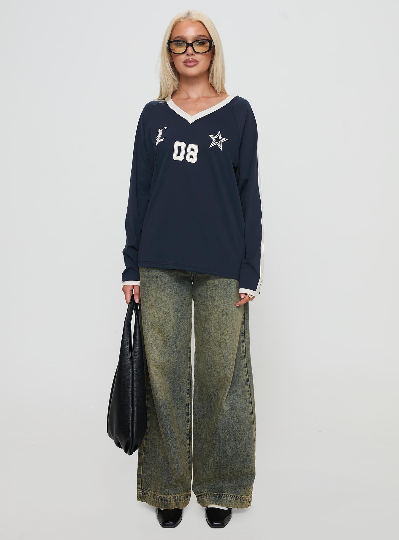 side view of model wearing Princess Polly Spectate Top Long Sleeve Navy Full Sleeves V-Neck 