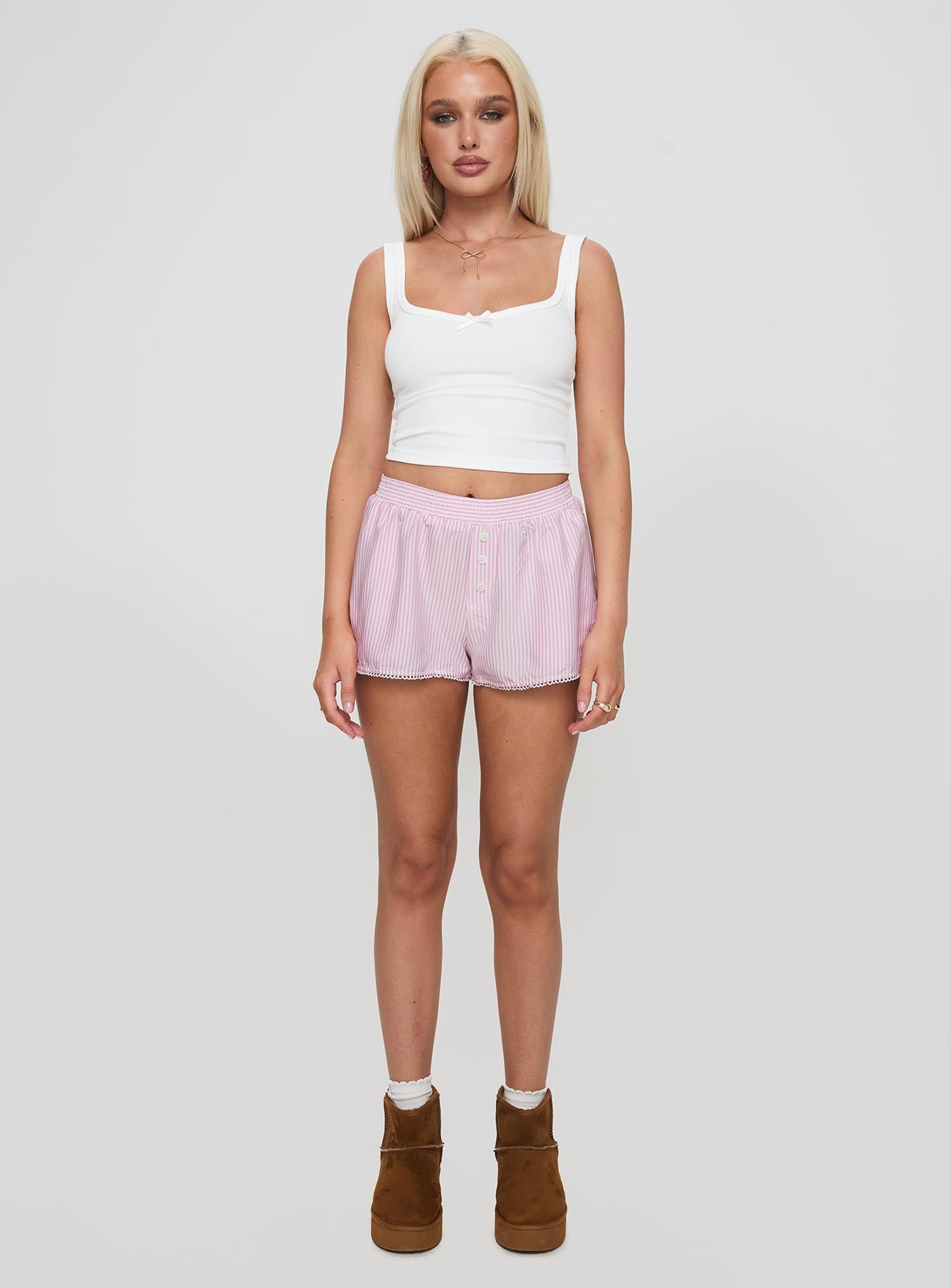 side view of model wearing Princess Polly Orielle Low Rise Boxer Short Pink High Waisted Shorts 