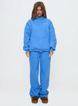 front view of model wearing Princess Polly Princess Polly Wide Leg Track Pant Bubble Text Blue High Waisted Pants 