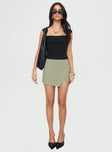 front view of model wearing Princess Polly Maceline Wrap Front Skort Green 