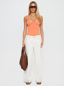 side view of model wearing Princess Polly Slow Jams Bodysuit Orange Sleeveless 