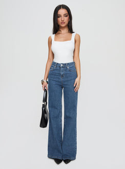 side view of model wearing Princess Polly Lucille High Rise Flare Leg Jeans Mid Wash High Waisted 