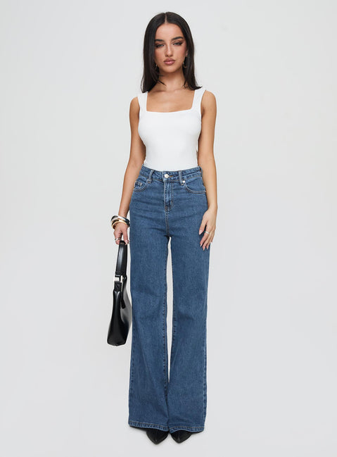 side view of model wearing Princess Polly Lucille High Rise Flare Leg Jeans Mid Wash High Waisted 