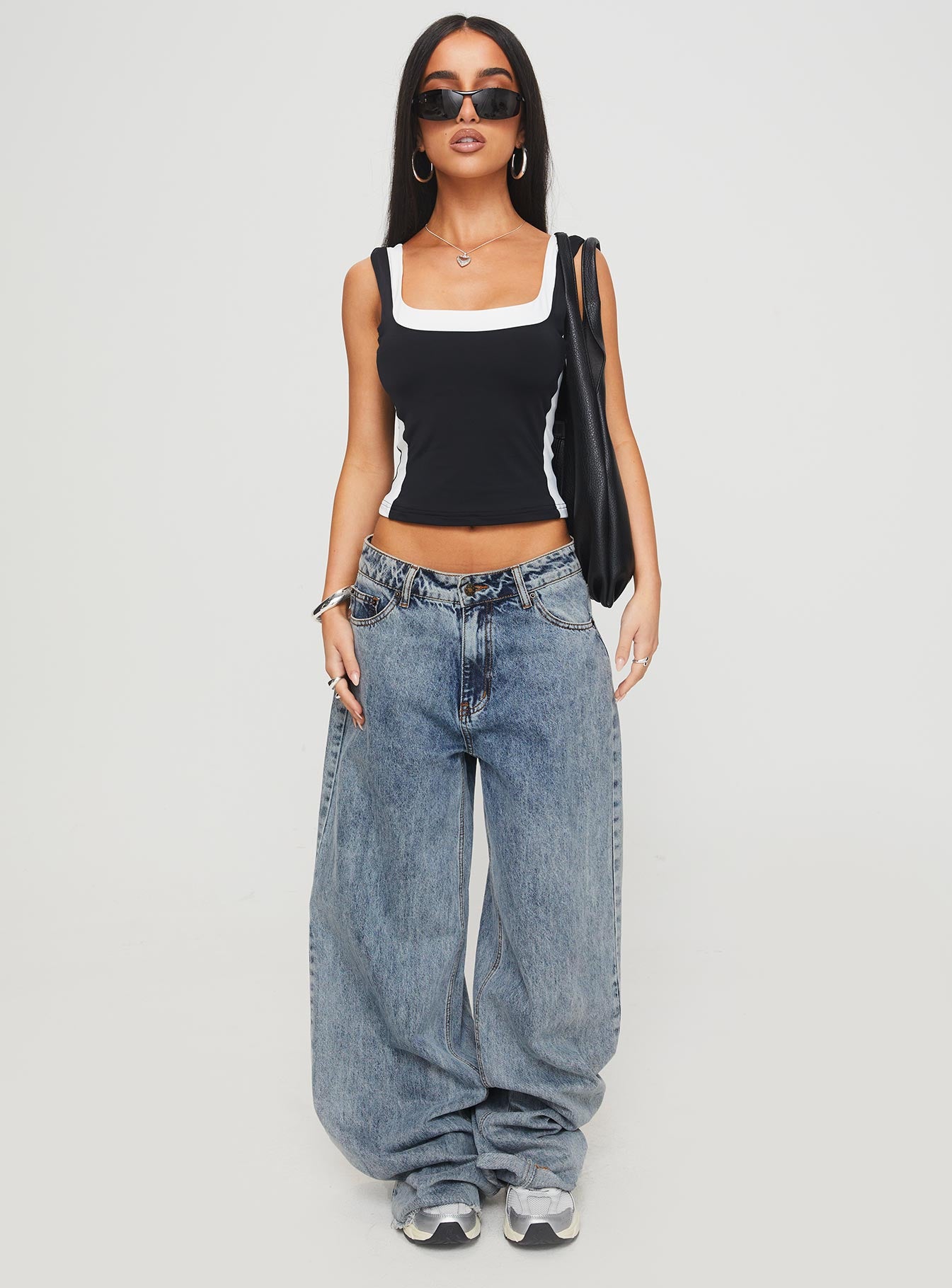 front view of model wearing Princess Polly Ayu Top Black Sleeveless Square Neck 