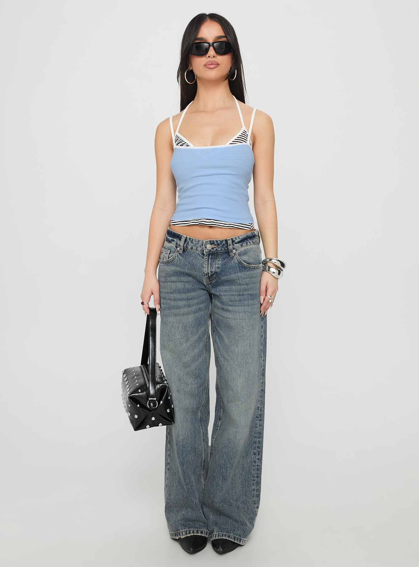front view of model wearing Princess Polly Zaralyn Low Rise Wide Leg Jeans Mid Blue Wash Low Rise Jeans 