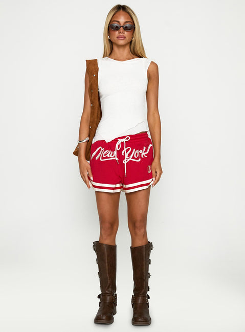 side view of model wearing Princess Polly Ny Trackstar Shorts Red Low Rise Shorts 