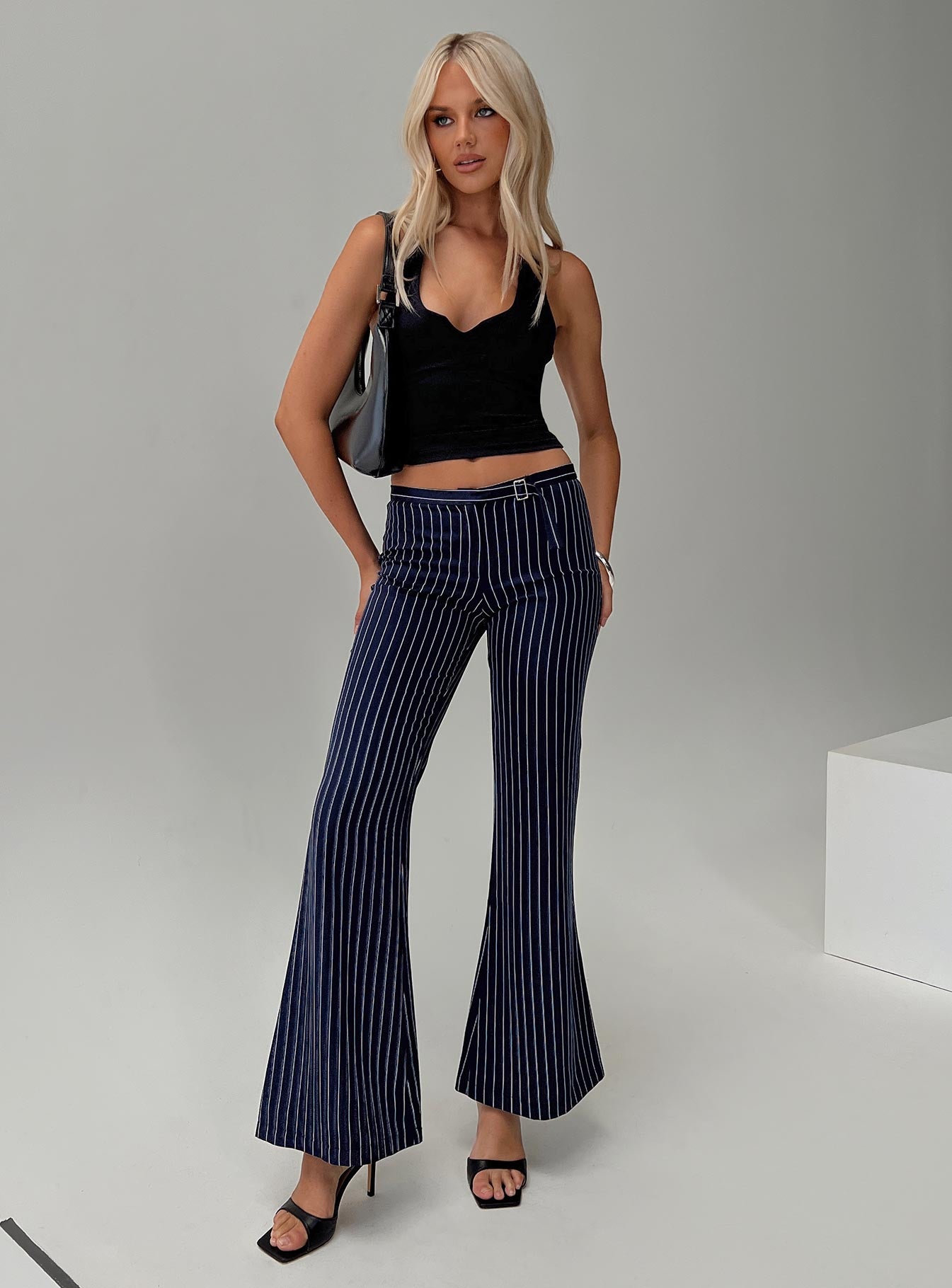 front view of model wearing Princess Polly No One Low Waist Pinstripe Pants Navy Mid Rise 