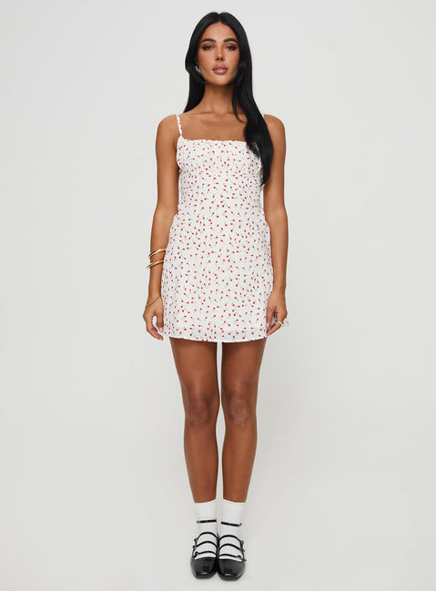 side view of model wearing Princess Polly Foleys Mini Dress White / Red Floral Square Neck 