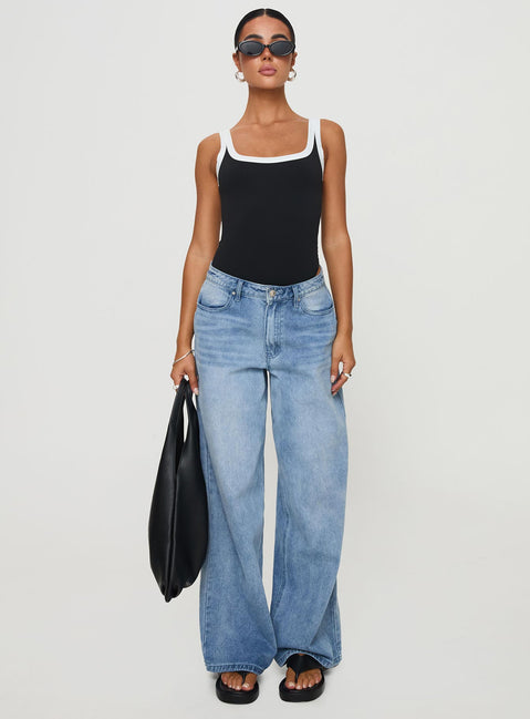 side view of model wearing Princess Polly Astrea Bodysuit Black / White Sleeveless 