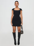 front view of model wearing Princess Polly Ravenna Mini Dress Black Scoop Neck 