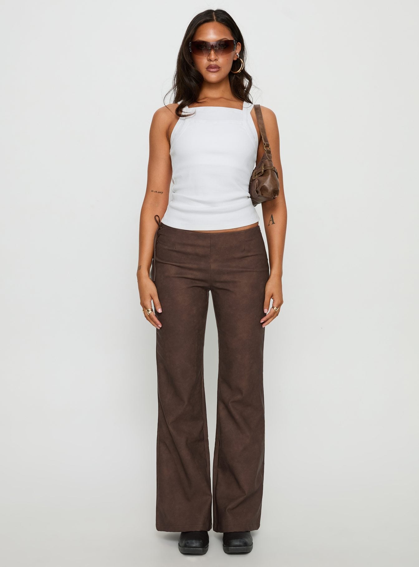 front view of model wearing Princess Polly Trickrider Tie Side Faux Leather Pants Chocolate Mid Rise Pants 