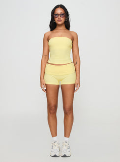 side view of model wearing Princess Polly Baseline Low Rise Rib Shorts Yellow Low Rise Shorts 