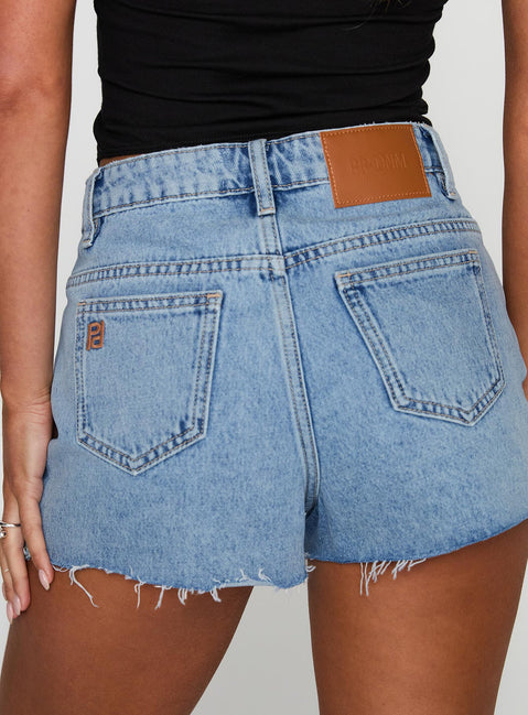 back view of model wearing Princess Polly Top Tier Mid Rise Denim Shorts Light Wash High Waisted Shorts 