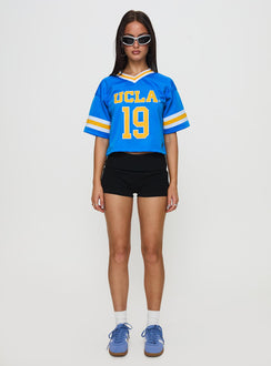 back view of model wearing Princess Polly UCLA Football Jersey Blue Half Sleeves V-Neck 