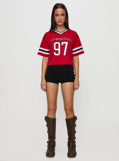 side view of model wearing Princess Polly SDSU Football Jersey Red Half Sleeves V-Neck 