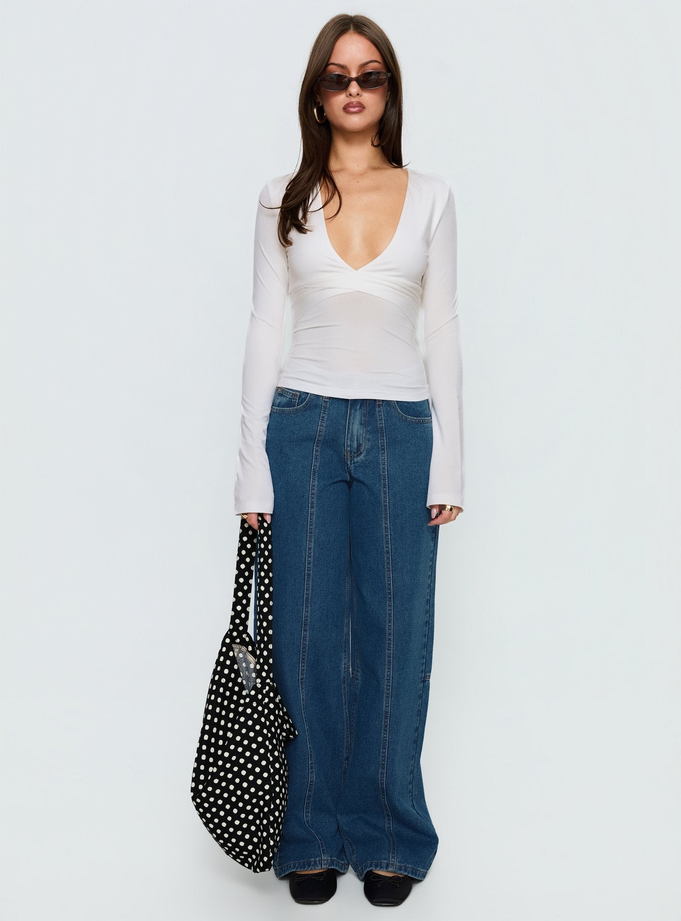 side view of model wearing Princess Polly Lando Low Rise Straight Leg Jeans Mid Blue Wash Mid Rise Jeans 