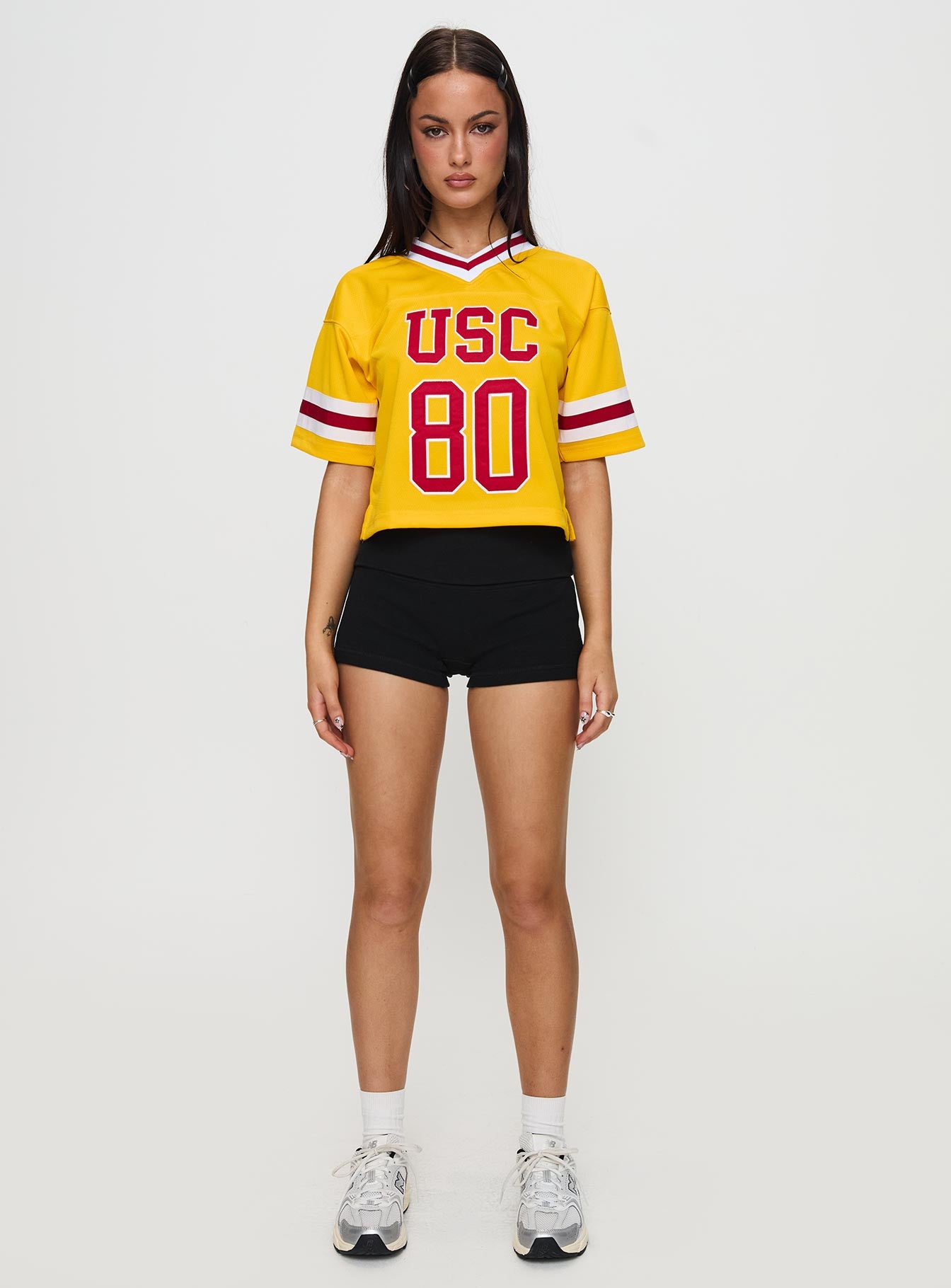 front view of model wearing Princess Polly USC Football Jersey Gold Half Sleeves V-Neck 