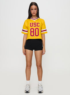 front view of model wearing Princess Polly USC Football Jersey Gold Half Sleeves V-Neck 