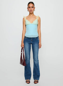 side view of model wearing Princess Polly Delvonte Top Blue / Yellow Sleeveless V-Neck 