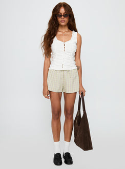 side view of model wearing Princess Polly Almeda Button Up Top White Sleeveless Scoop Neck 