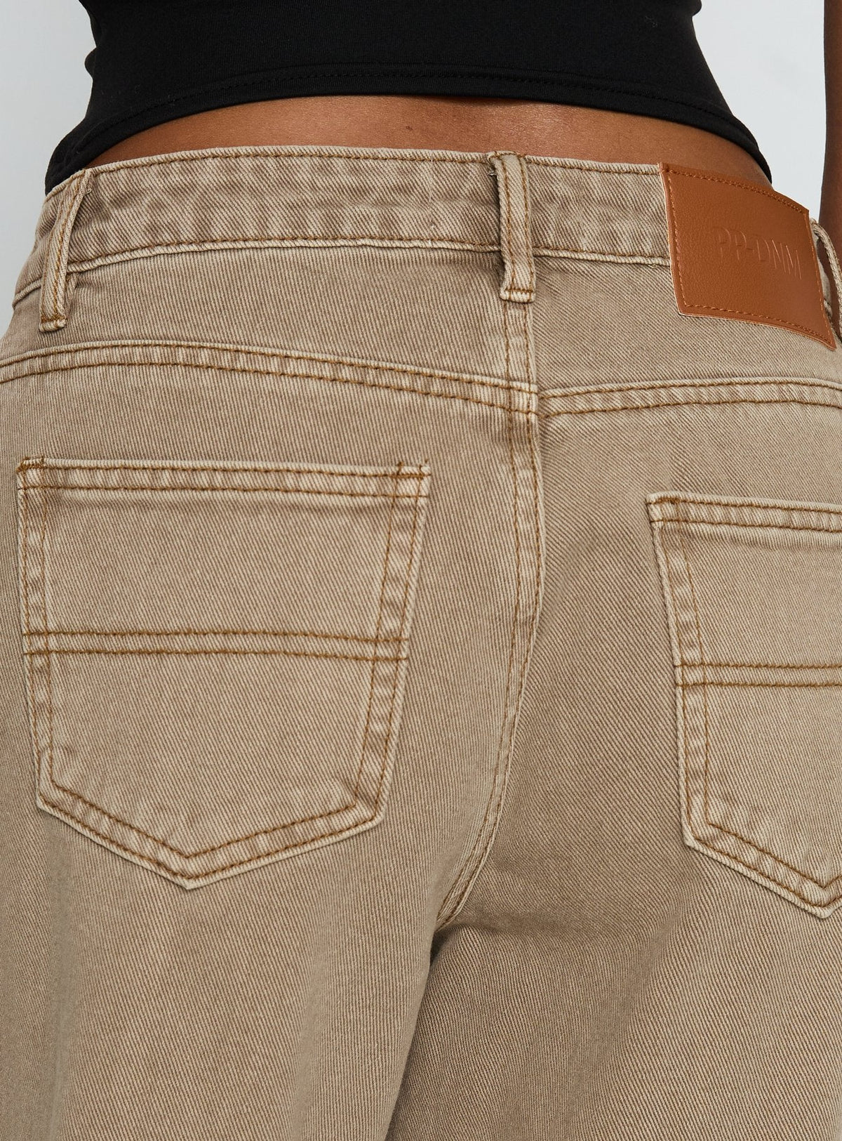 side view of model wearing Princess Polly Naylor Mid Rise Wide Leg Jeans Light Brown Wash Mid Rise Jeans Jeans 