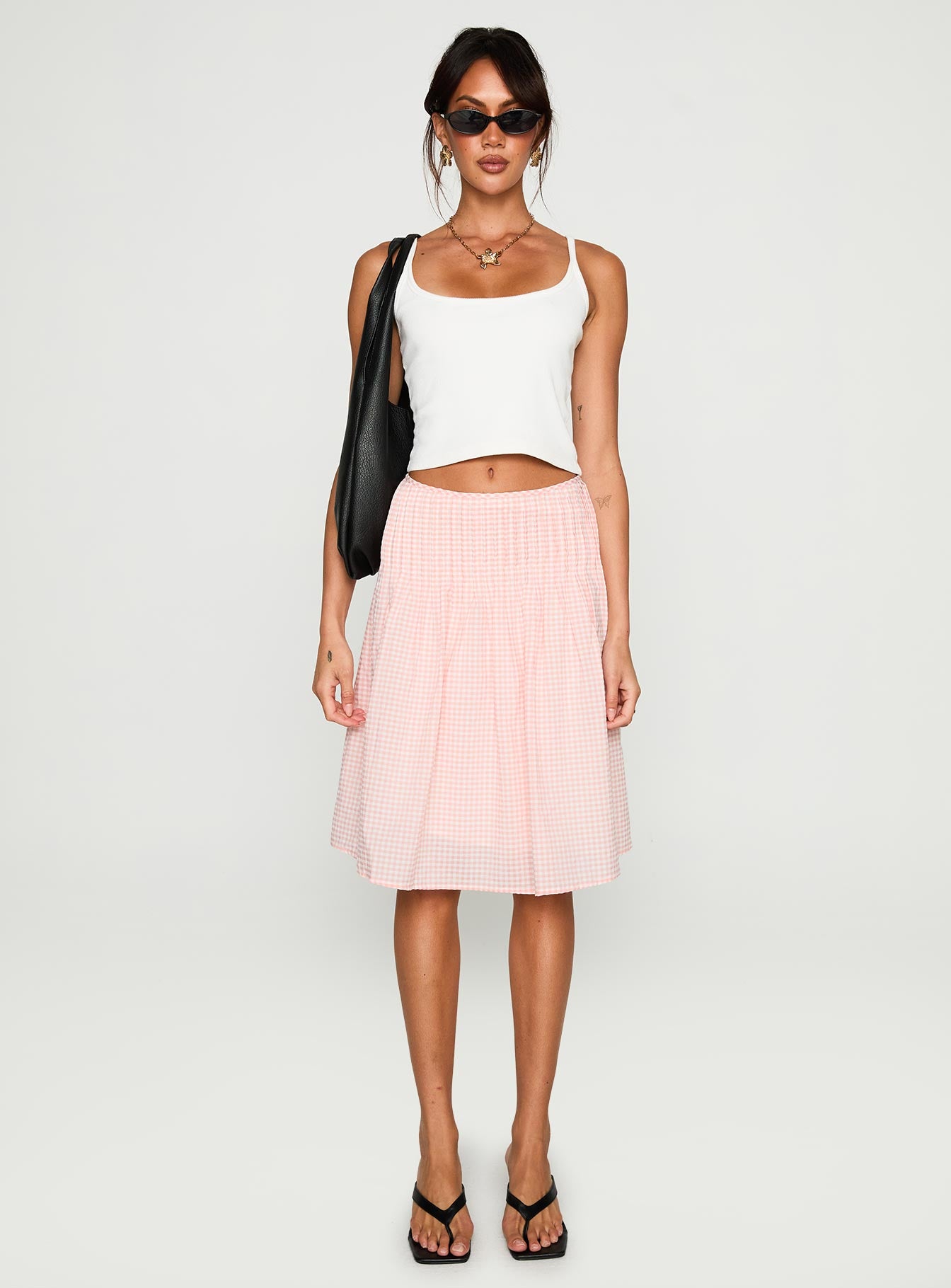   side view of model wearing Princess Polly Maryanna Midi Skirt Pink Gingham 