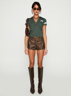 side view of model wearing Princess Polly Polo 78 Top Green Short Sleeves V-Neck 