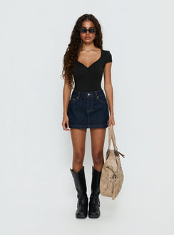 back view of model wearing Princess Polly Nicolina Low Rise Denim Mini Skirt Raw Denim Mini Skirts 