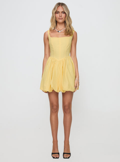 back view of model wearing Princess Polly Alcott Bubble Hem Mini Dress Lemon Square Neck 