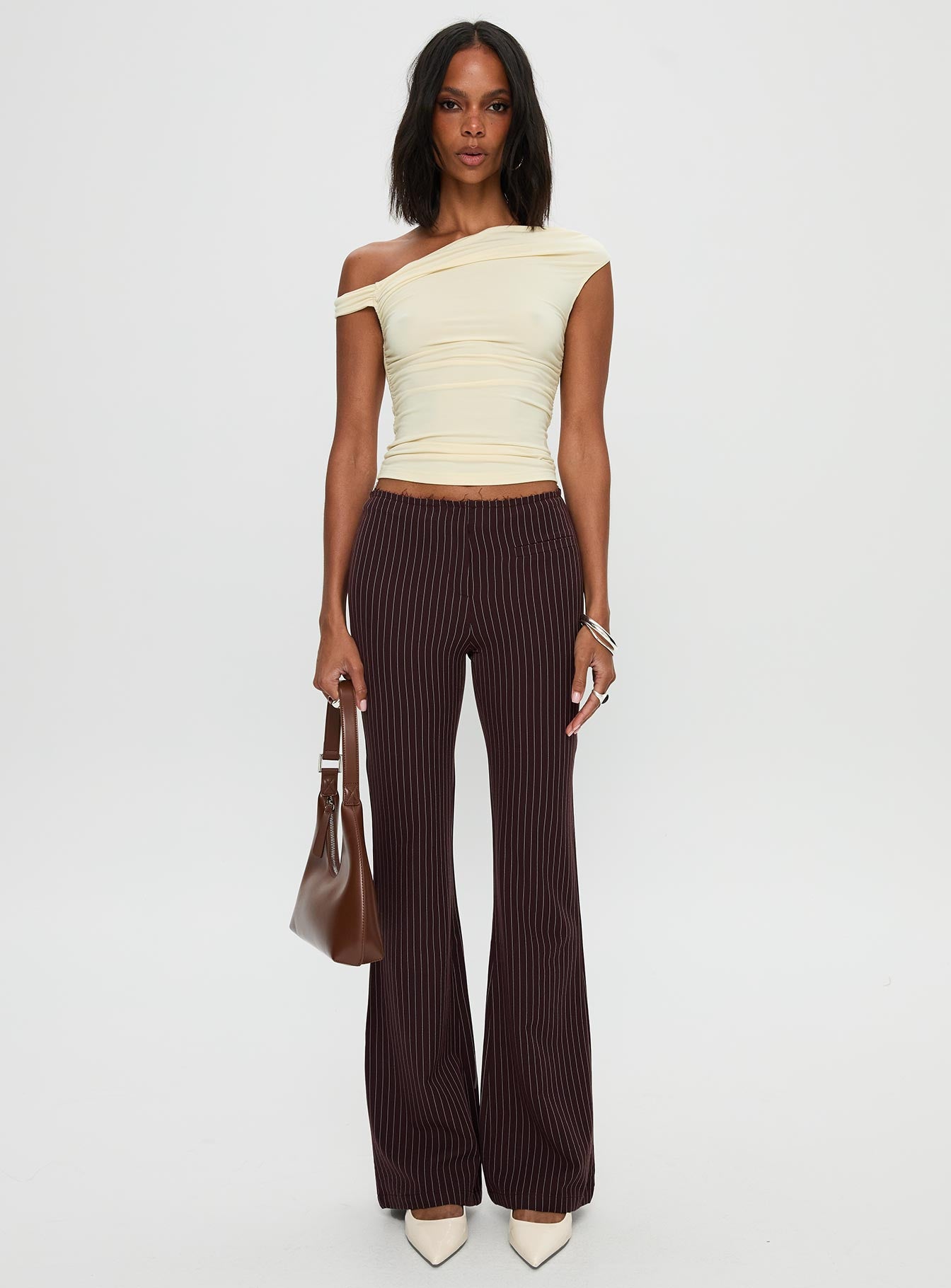 side view of model wearing Princess Polly Sportia Flare Pants Brown High Waisted Pants 