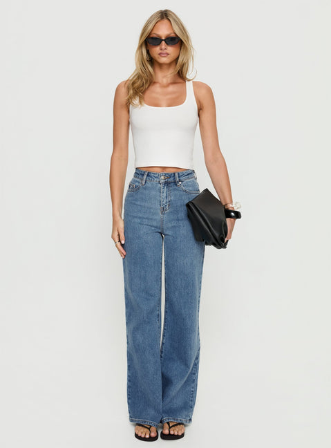 front view of model wearing Princess Polly Thearlie High Rise Flared Jeans Mid Blue Wash High Rise Jeans 