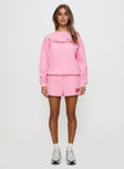 side view of model wearing Princess Polly Princess Polly Sweat Short Bubble Text Pink / Red High Waisted Shorts 